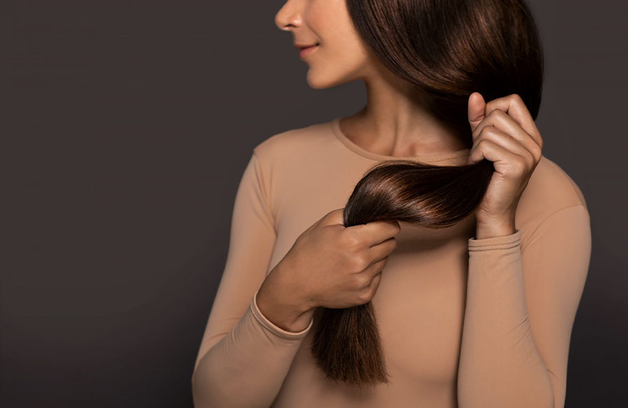 woman-holding-her-brown-hair