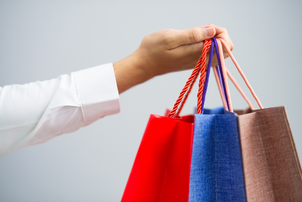 closeup-man-holding-shopping-bags