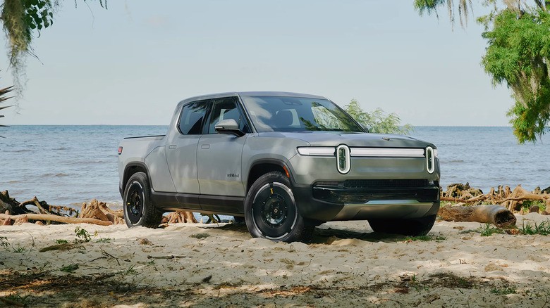 least-reliable-car-brands-2025-5-a-gray-2025-rivian-r1t-parjed-on-a-beach