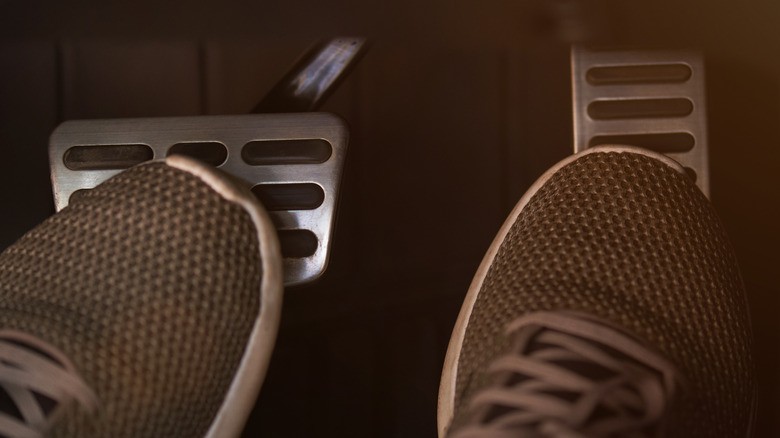 4-close-up-view-of-a-drivers-feet-on-car-pedals-with-one-foot-pressing-the-brake-and-the-other-on-the-gas-pedal