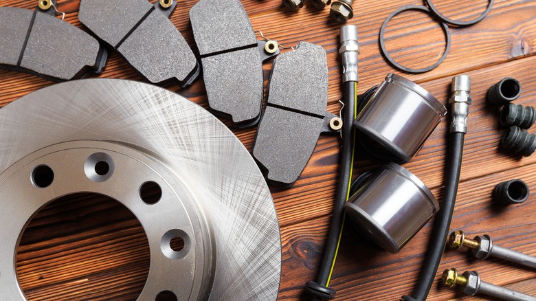 9-an-assortment-of-new-automotive-brake-components-laid-out-on-a-wooden-surface