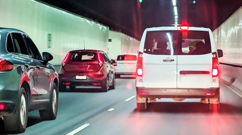 1-view-from-behind-several-vehicles-driving-through-a-tunnel-showing-a-white-van-on-its-brakes