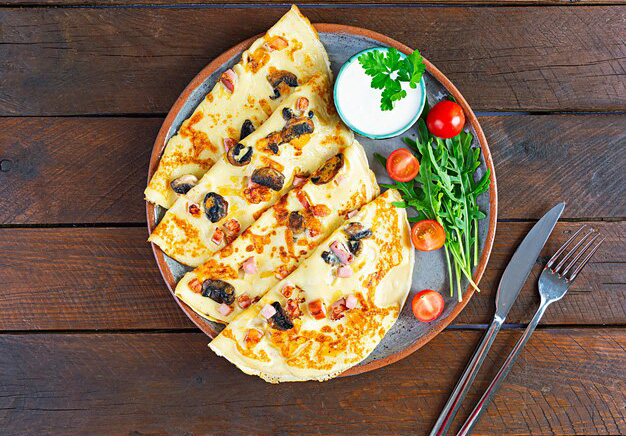 delicious-pancakes-with-mushrooms-ham-cheese-arugula-tomatoes-sour-cream_126783-621