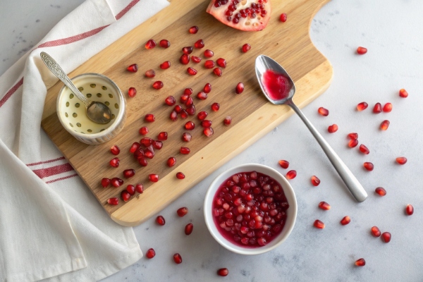 on-a-clean-cutting-board-evenly-scatter-pomegran