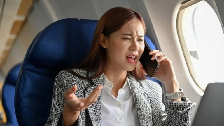 angry-businesswoman-on-call-in-plane-1-768x431