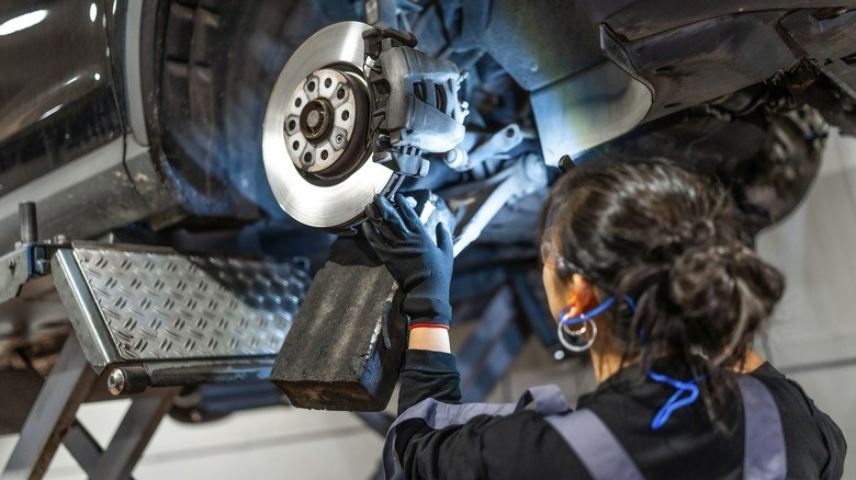 7-a-mechanic-working-on-the-brake-system-of-a-raised-car