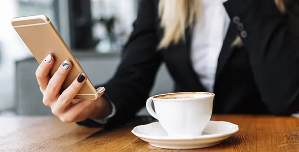 blonde-business-woman-sitting-indoors-cafe-Top
