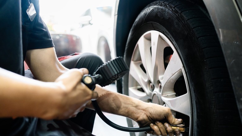 tire-blowout-warning-signs-1-tire-pressure-gauge-being-used-to-check-pressure