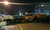 صف‌ کامیون‌ در پلاسکو برای خاک برداری